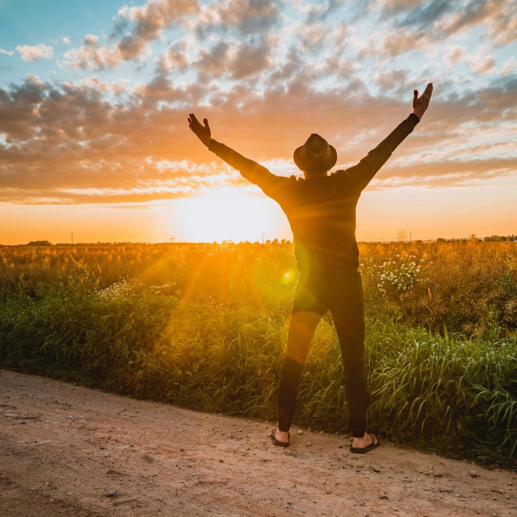 Man with open arms facing sunlight, symbolizing hope and empowerment in ADHD skills group
